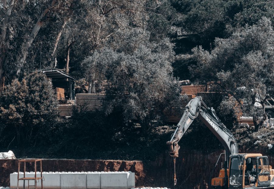 Excavator working a large open cut for a commercial septic field